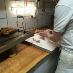 Completing the Krawatte doughnut with sugar at Bakery Roth in Erfurt