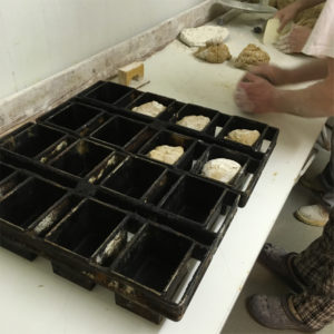 Spelt Bread dough being filled into form